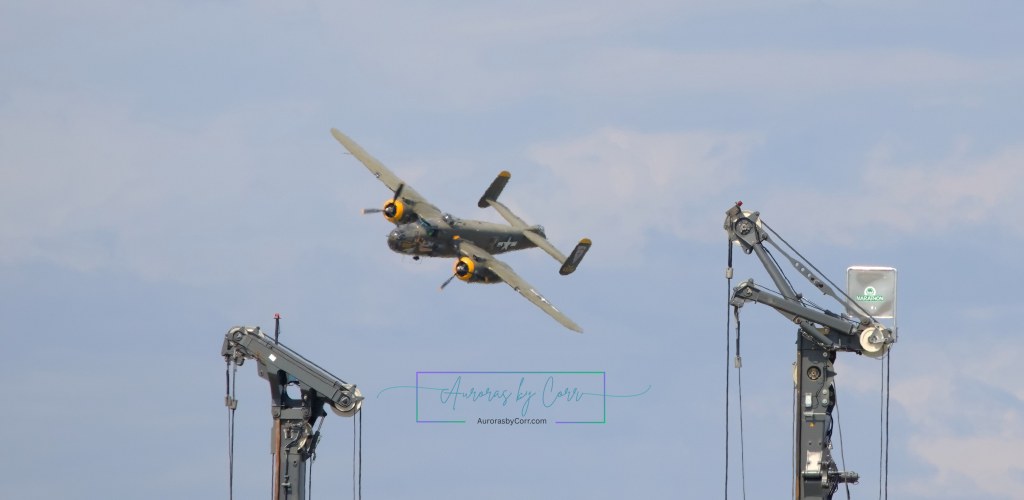 The heritage B-25 Mitchell dodges  construction cranes at the Cold Lake Air Show 2026.