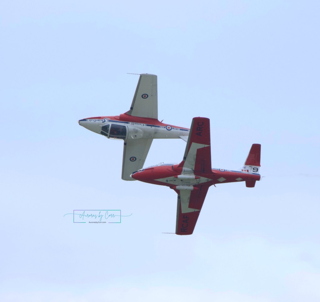 Two RCAF Snowbird soloists flying topsy turvy over one another at the Cold Lake Air Show 2026